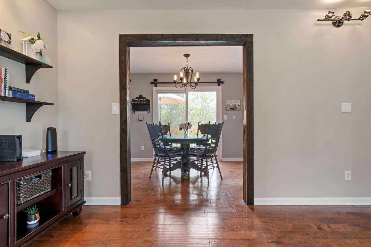 This view frames the dining area beautifully and showcases the natural flow leading right to the backyard through the sliding glass door.