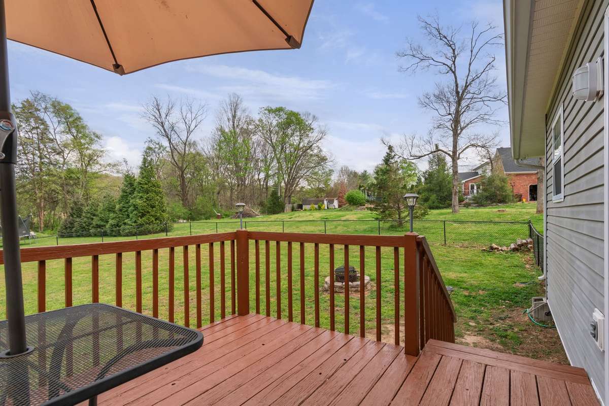 Enjoy a peaceful moment on the back deck while taking in the wide-open views of the yard.