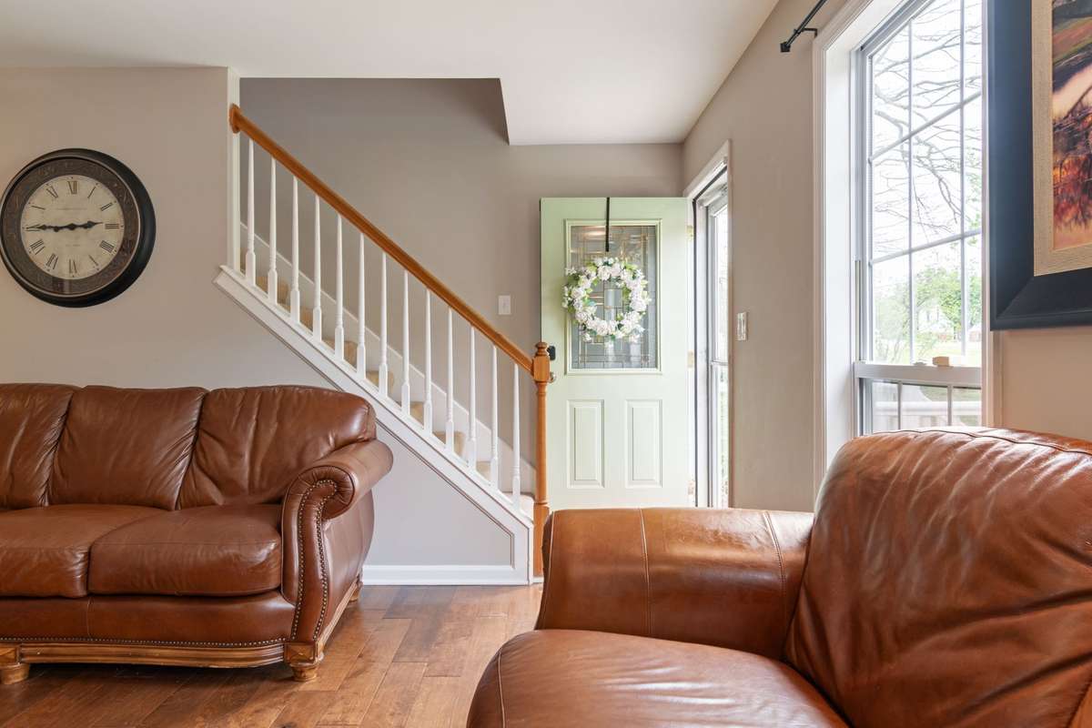 The charming front door and classic stair rail make a great first impression in this home.