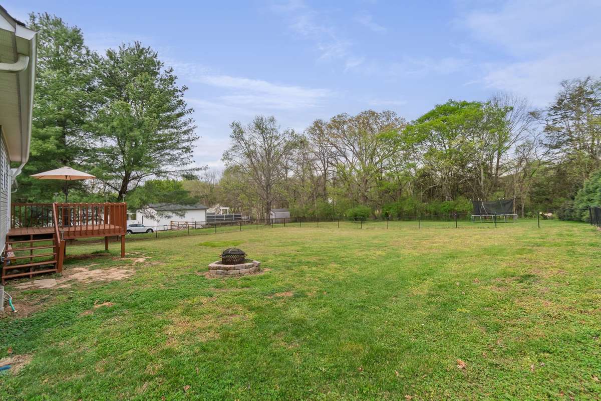 This spacious, level backyard offers plenty of room for play, entertaining, and relaxing around the firepit area.