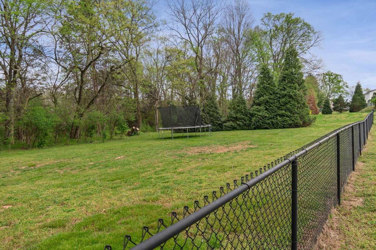 With generous space and natural surroundings, the backyard offers a wonderful setting for everyday living and weekend get-togethers.