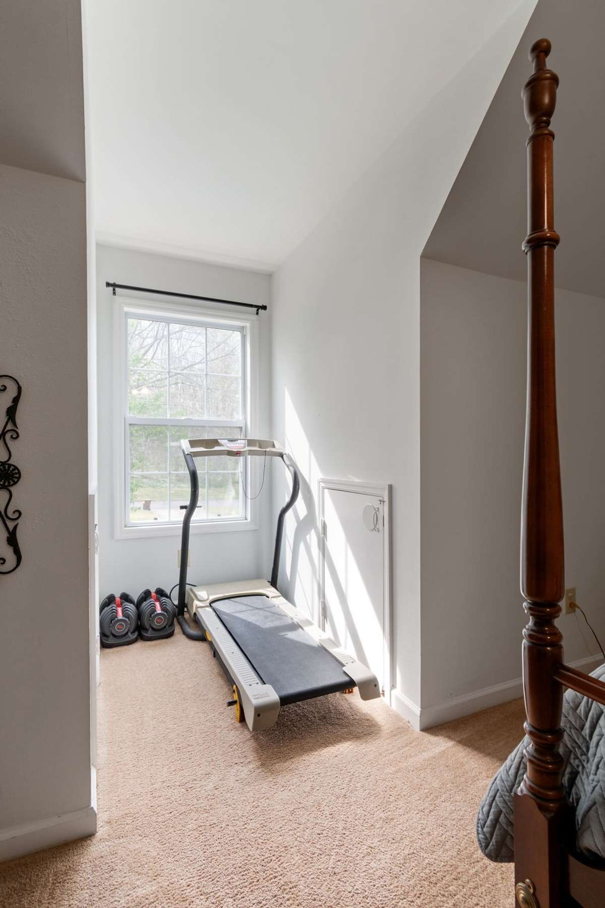 Tucked into a sunny nook, this addition space is perfect for a workout corner, reading spot, or extra storage.