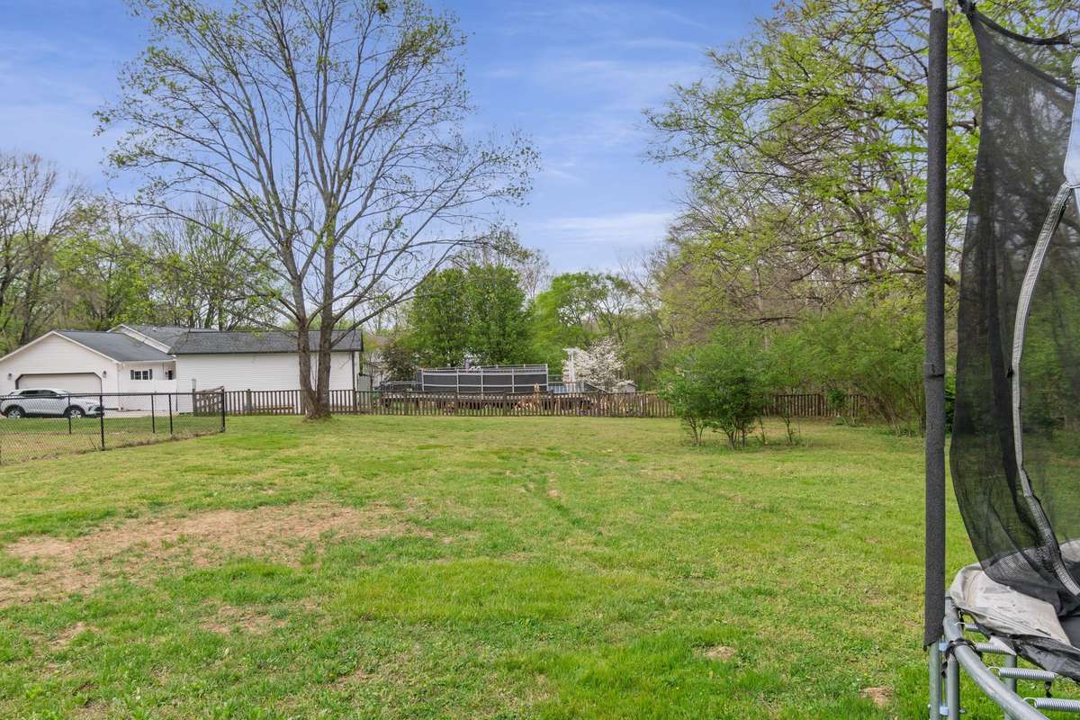 With generous space and natural surroundings, the backyard offers a wonderful setting for everyday living and weekend get-togethers.