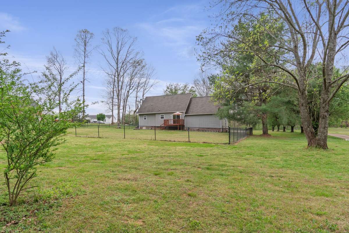 From this wide backyard view, you can appreciate the home’s outdoor space and the easy flow to the deck.