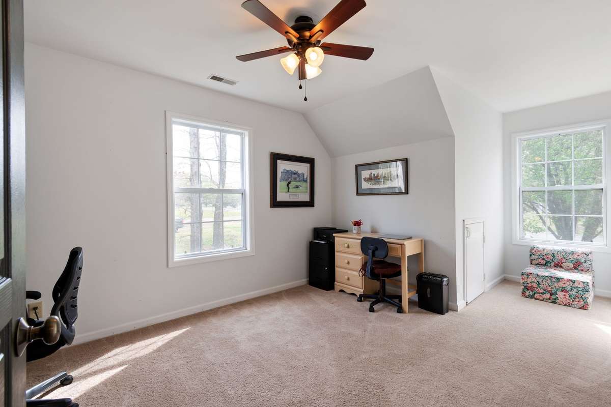Sunlight pours into this flexible upstairs room. The space is perfect for a home office, hobby room, or cozy retreat.
