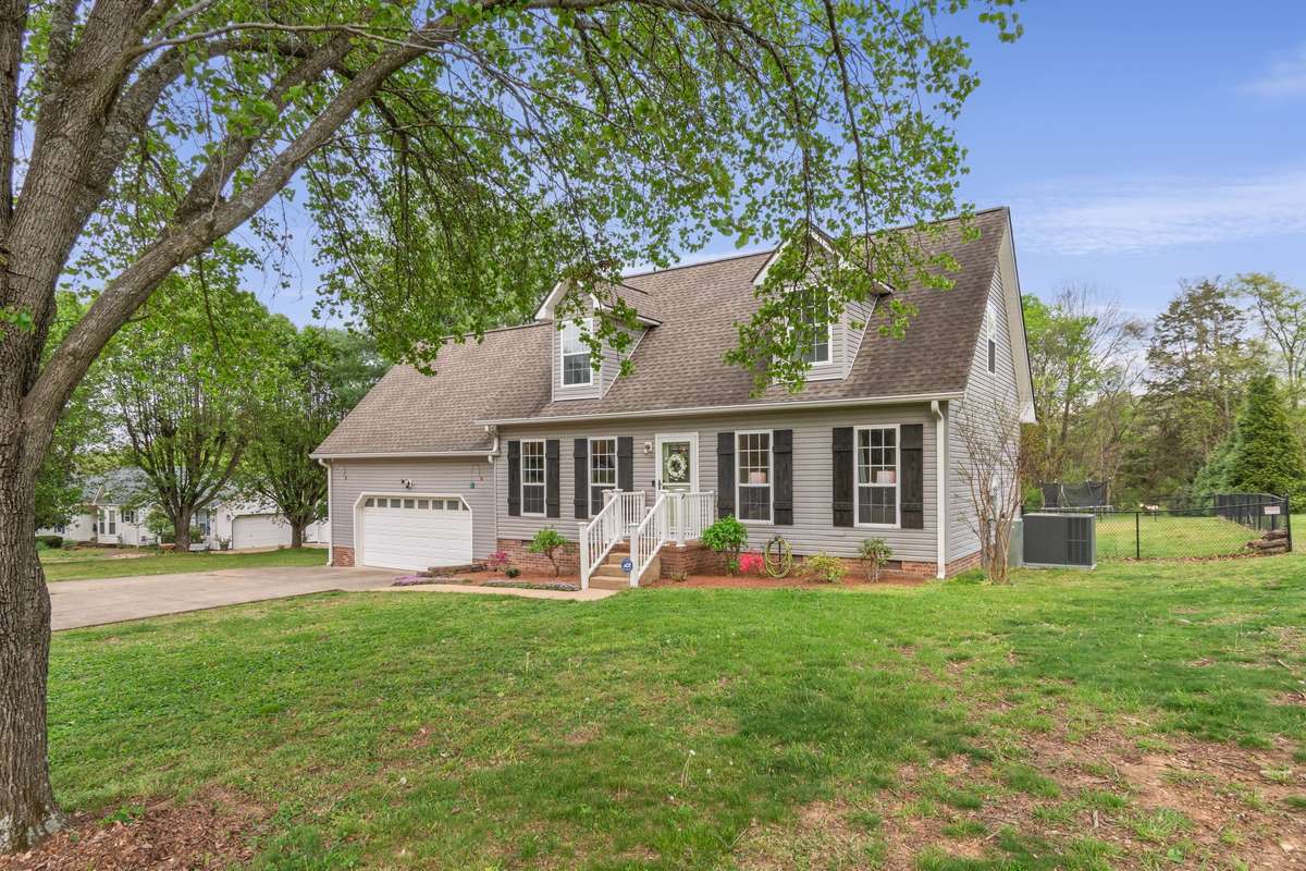 Set beneath mature trees, the home enjoys a peaceful front setting with a spacious lawn and lovely curb appeal.