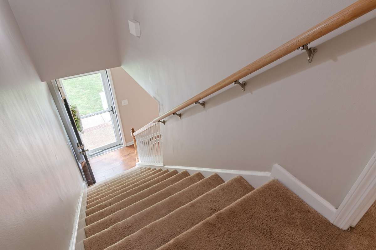 The carpeted staircase provides a comfortable, easy flow between levels, tying the home together with a practical layout.