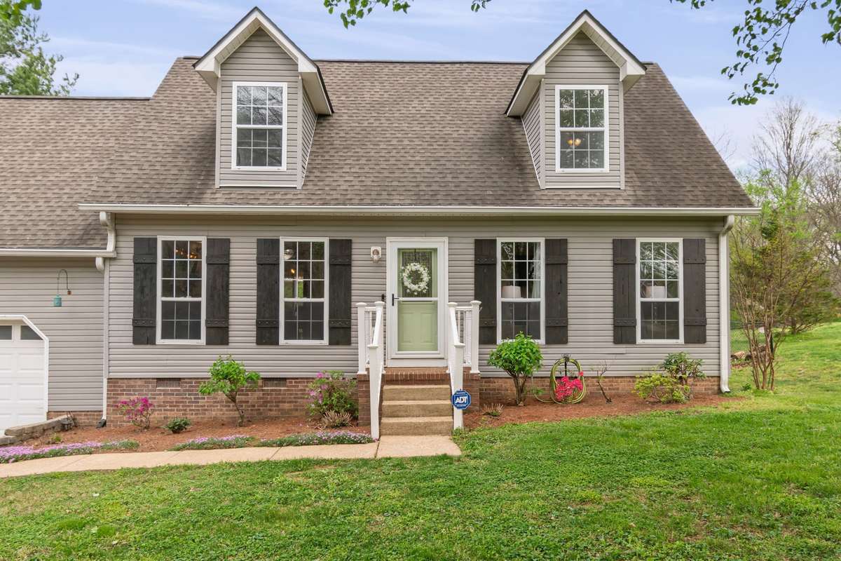The cheerful front door and porch create a friendly first impression. Perfect for greeting guests and coming home each day.