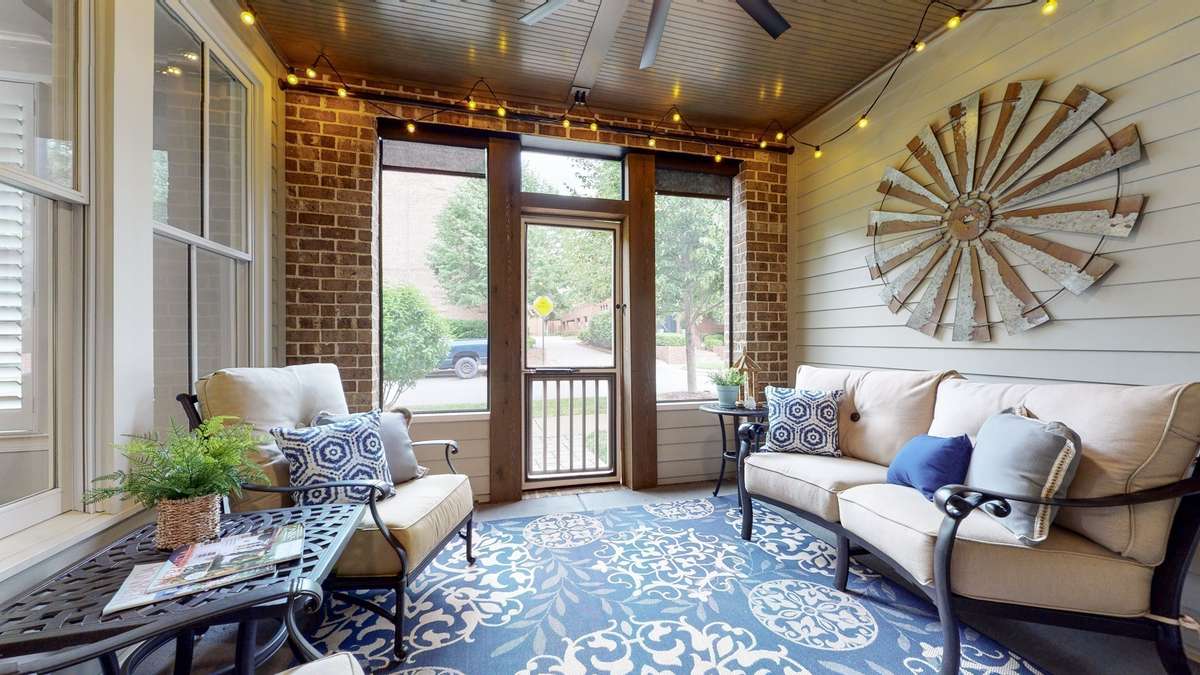 Screened porch with 9 foot ceiling, bead board and a paver path to the sidewalk