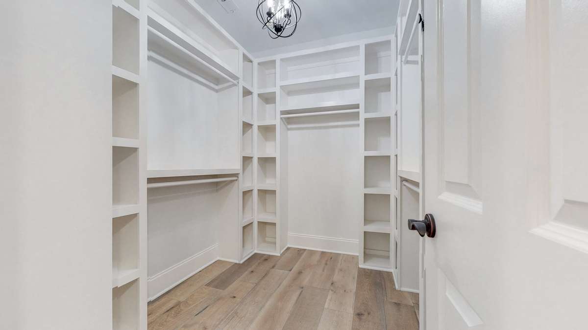 Primary walk-in closet with built ins