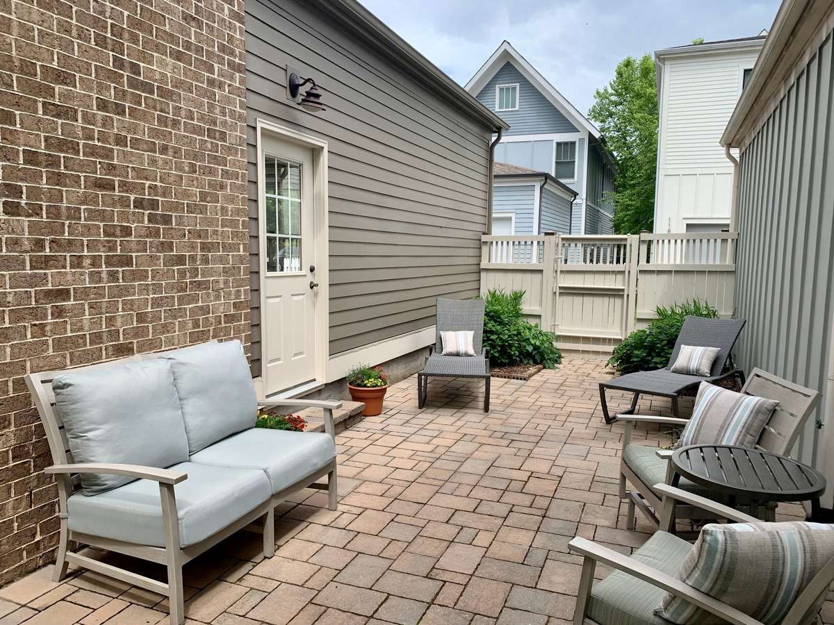 Private courtyard features paver patio and gate to alley