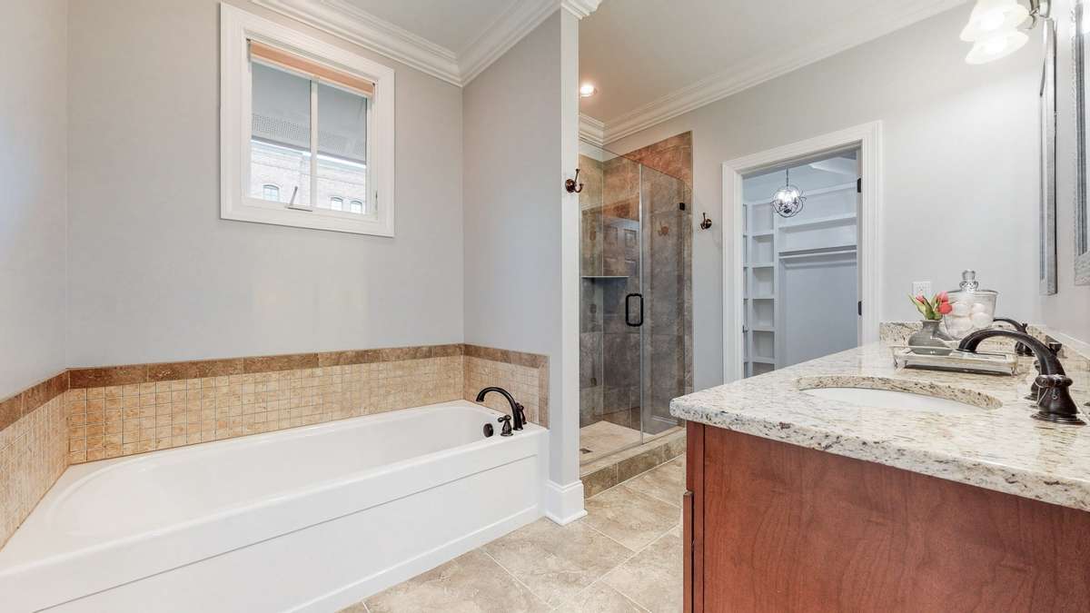 Primary bathroom includes a 6 foot tub, separate tiled shower and double sinks