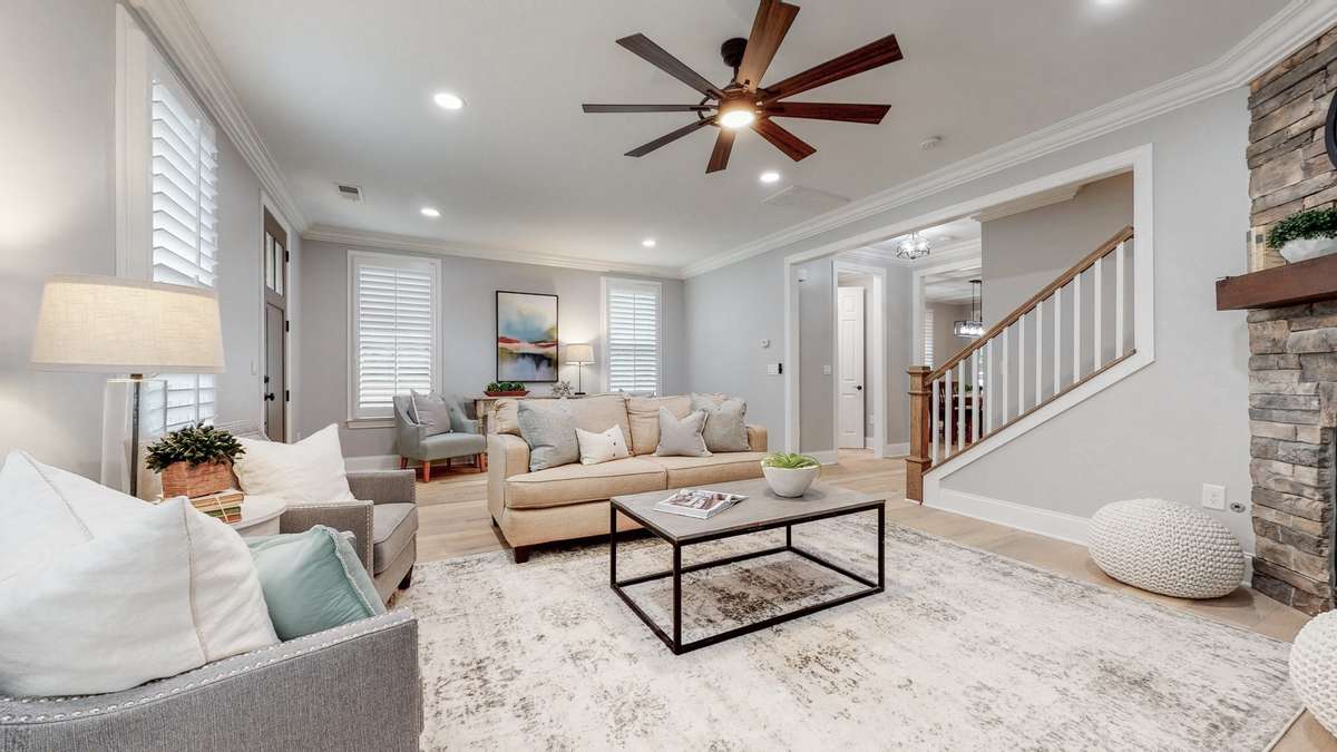 Spacious living room with 9 foot ceilings and crown moulding
