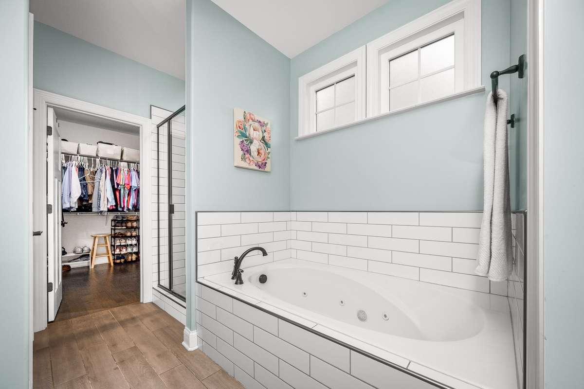 Jetted soaking tub with tile surround is perfect after a long day at the office or with the kids.