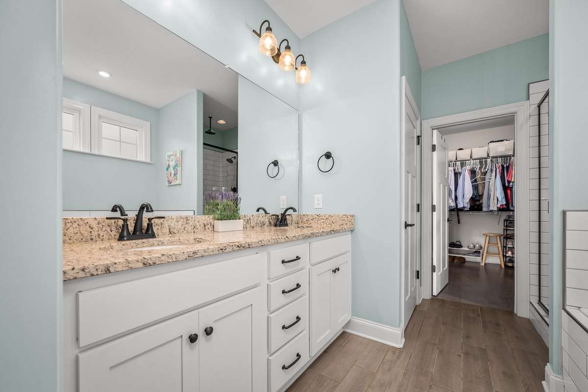 Granite double vanity and comfort height cabinets are on trend.