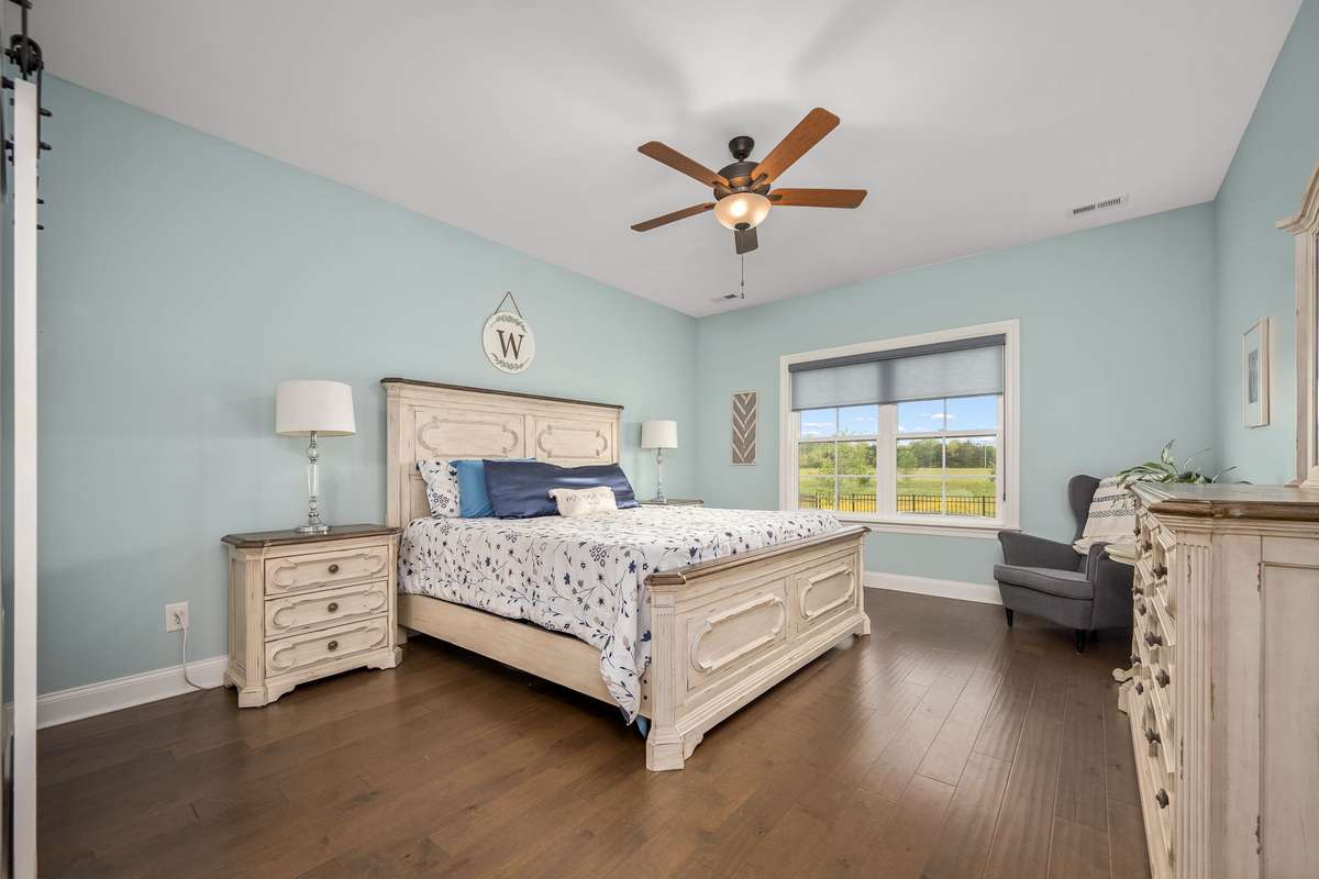 Primary bedroom is on the first floor and also features the LVP flooring. This is a king size bedroom suite and there is still plenty of space for extra pieces.