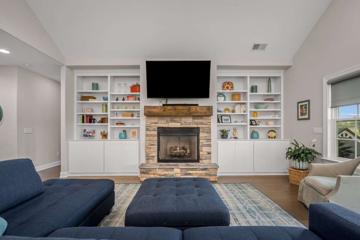 Built in bookcases give you room to display your collectibles, your books, family photos or whatever brings you joy.  They surround a beautiful stone fireplace with gas logs.