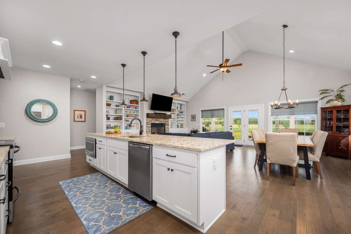 View showing the easy flow from kitchen to living space/dining area.