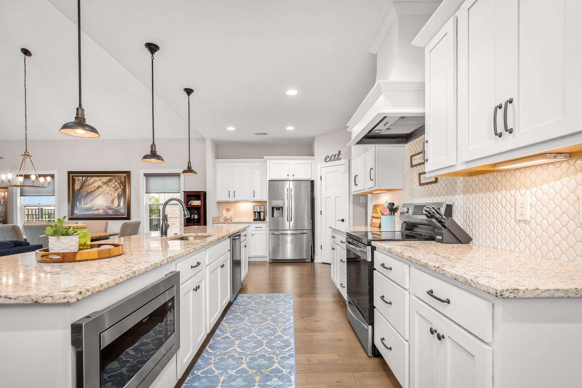 Enormous island is both beautiful and functional.  Roll out your Christmas cookies, meal prep for the week or feed the kids snacks while they study.   Above the oven enjoye a beautiful hood which vents to the outside.