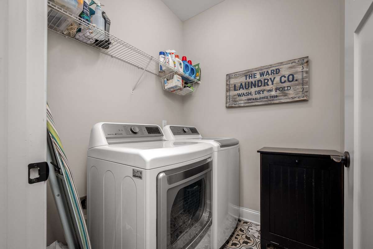 Laundry room with tiled floor is conveniently located.