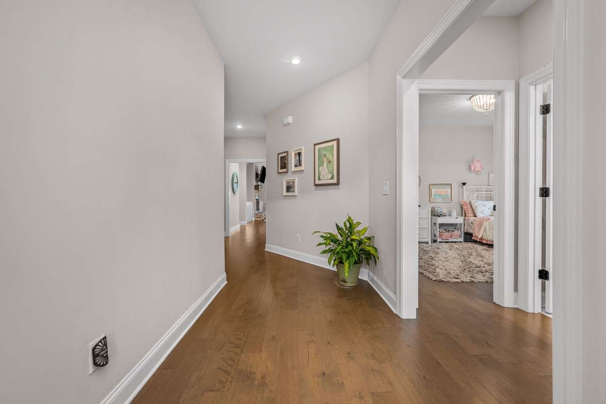 Welcoming foyer showcasing the neutral palette and luxury vinyl plank floors (LVP) that run throughout the entire downstiars.