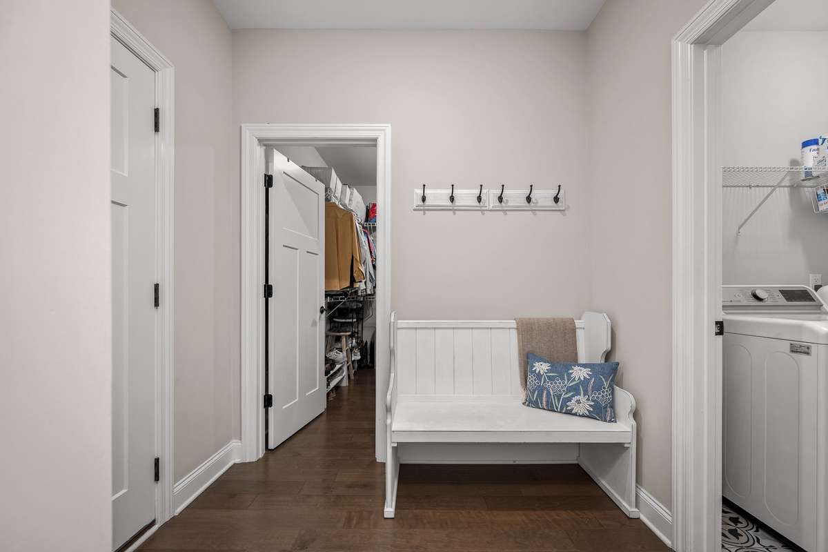 Drop zone outside of garage entry with opening to primary closet and Laundry room.