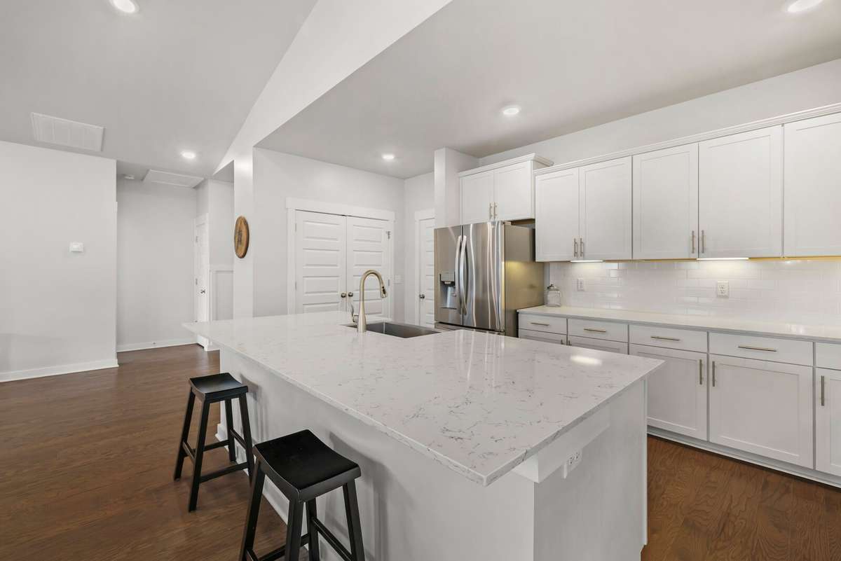 Room to gather and eat at the island or simply serve your guests buffet style. Double door pantry