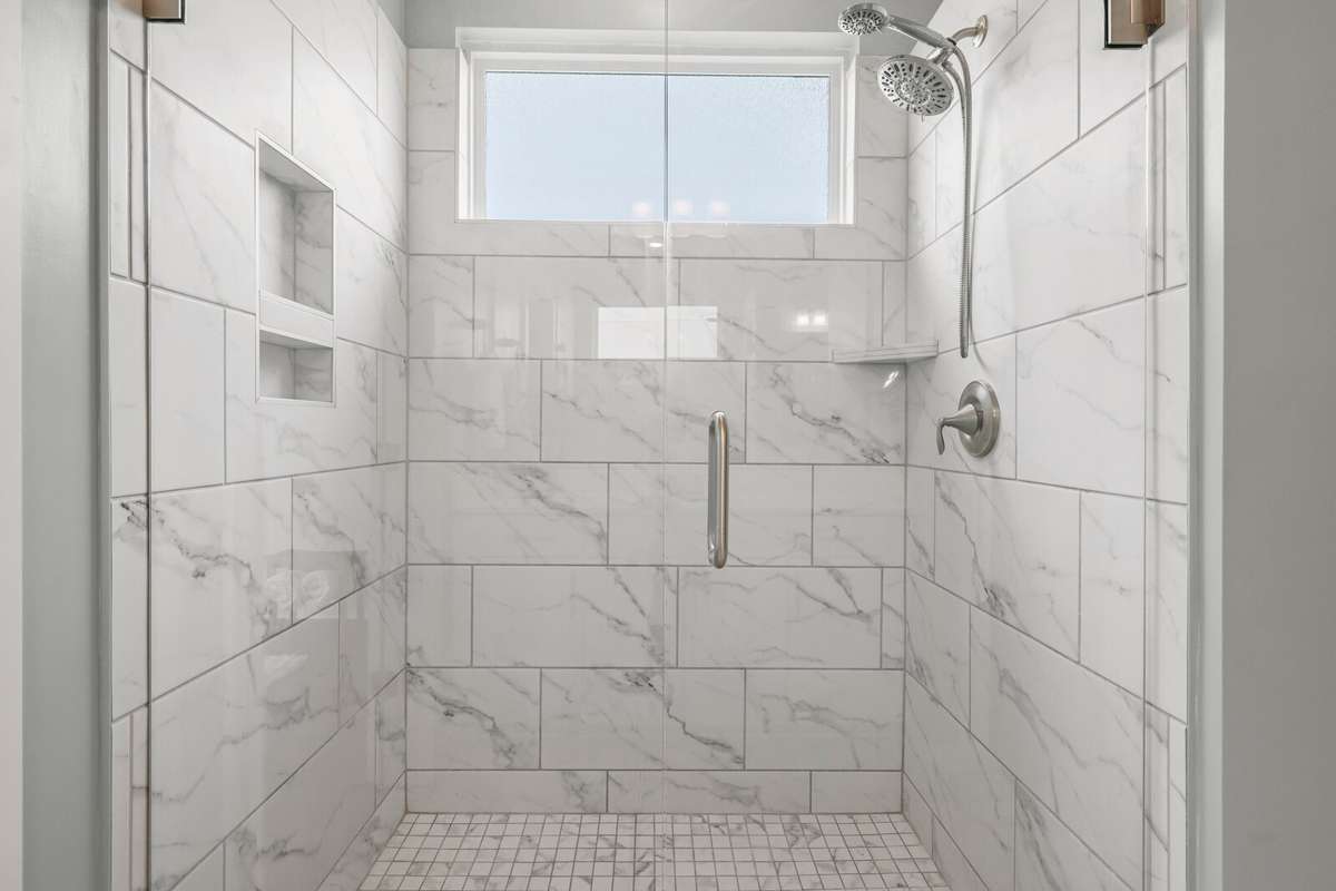 Fully tiled, large walk in shower in the primary bath