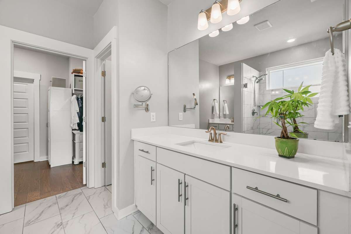 The primary bath enjoys his/her vanities with an abundance of counter space