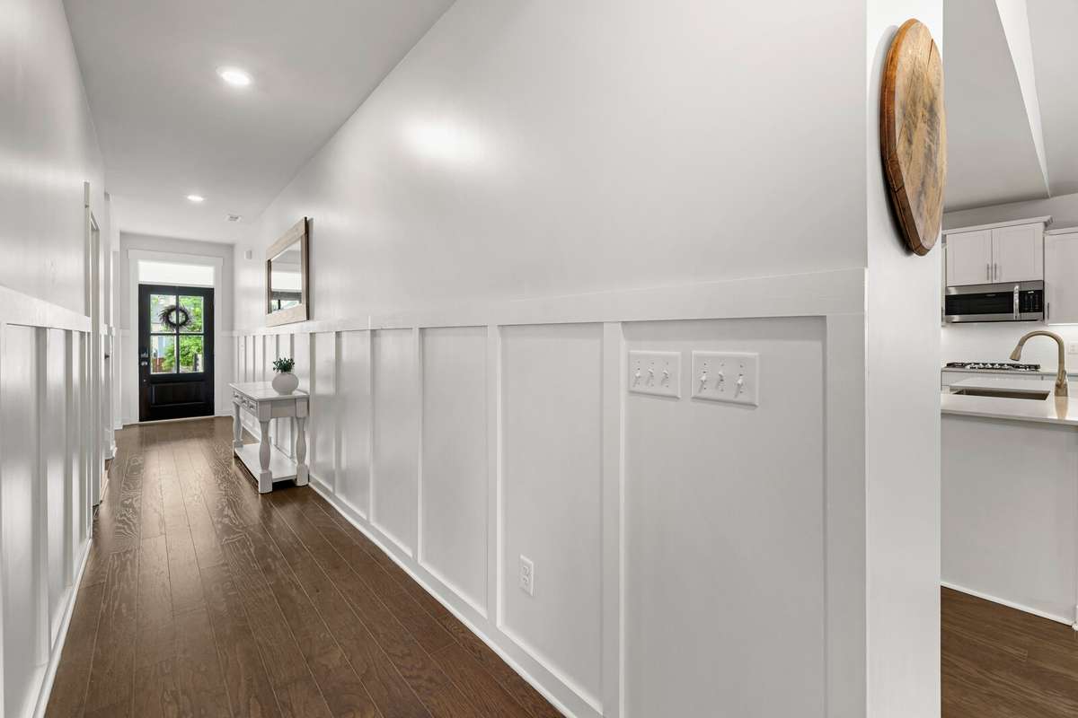 The hallway leads you into the open concept kitchen and gathering area