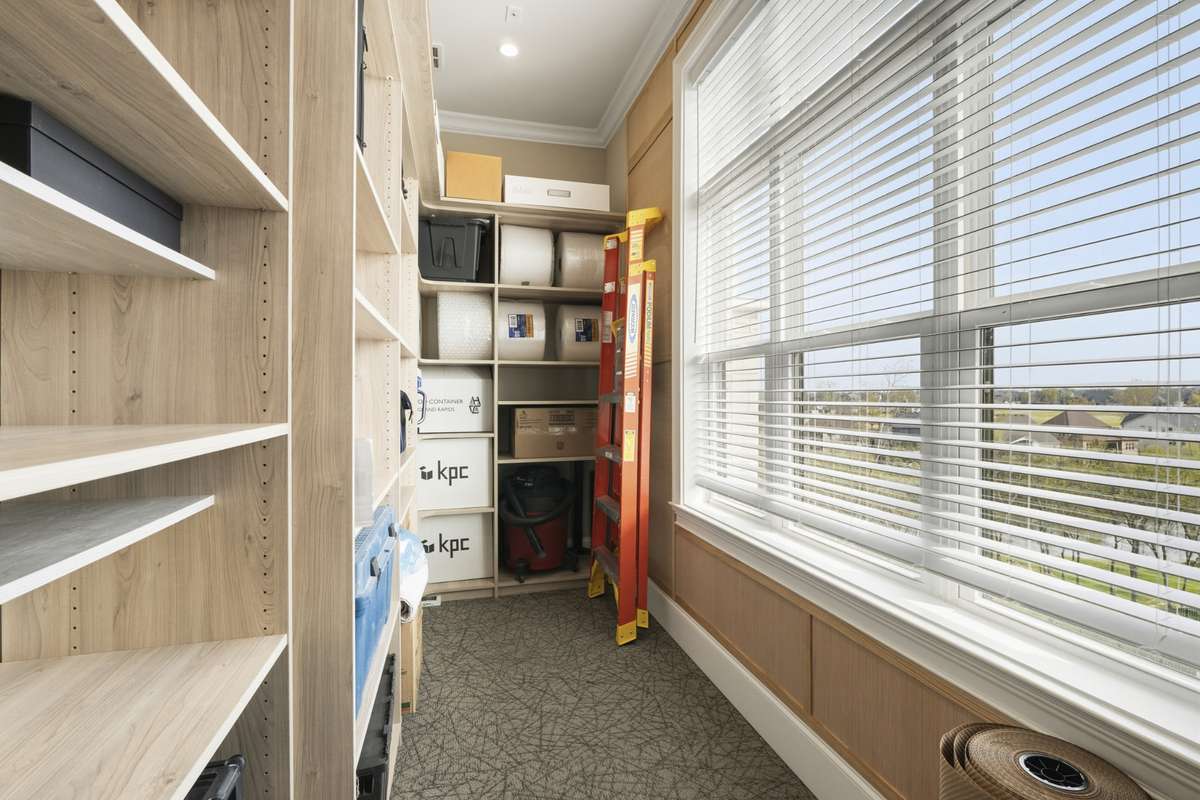 Large PRIVATE walk-in storage room located just outside your unit-featuring built-in shelving and natural light for ultimate convenience.