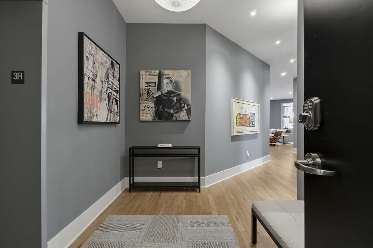 Wide-plank hardwood floors and clean, modern design create a welcoming first impression.
