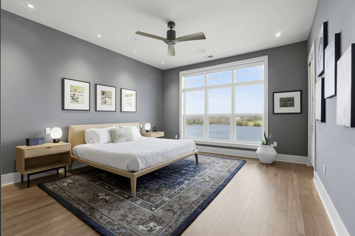 Spacious primary suite with oversized windows showcasing stunning Old Hickory Lake Views.