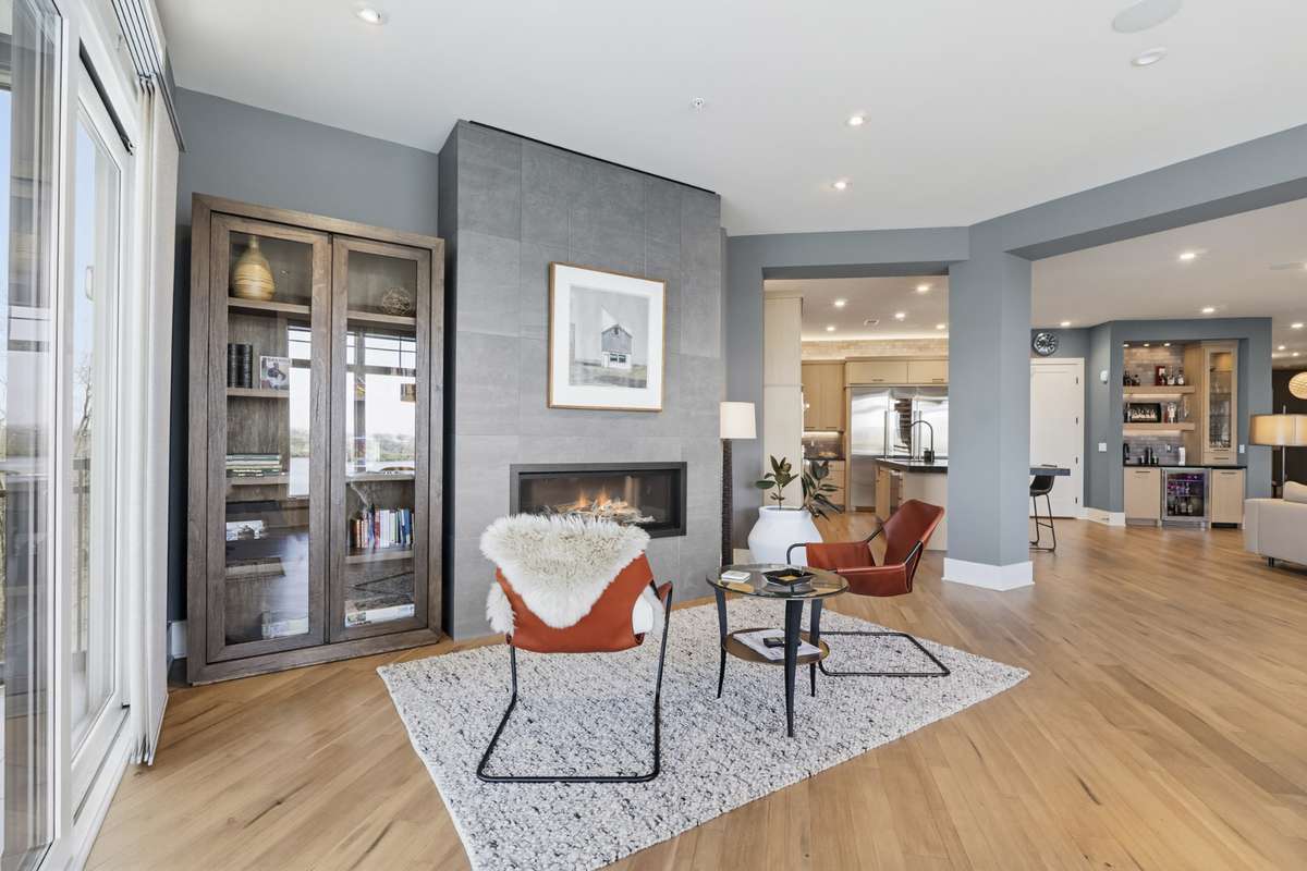 Modern linear fireplace creates a warm and inviting a secondary living space.