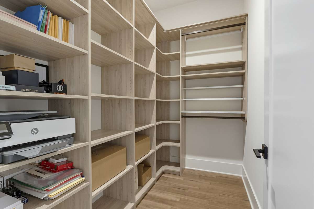 Expansive walk-in closet with custom shelving designed for organization and storage.