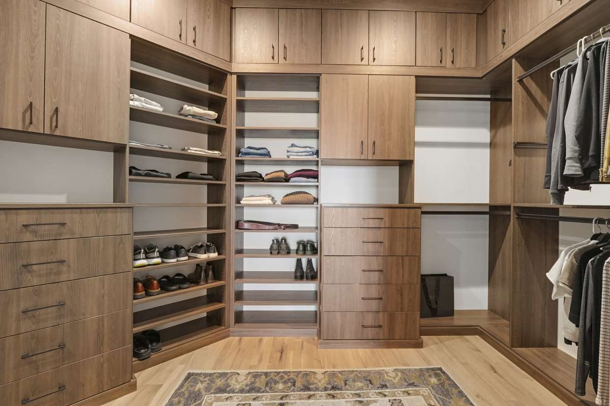 Custom walk-in closet with built-in shelving, drawers and exceptional storage.