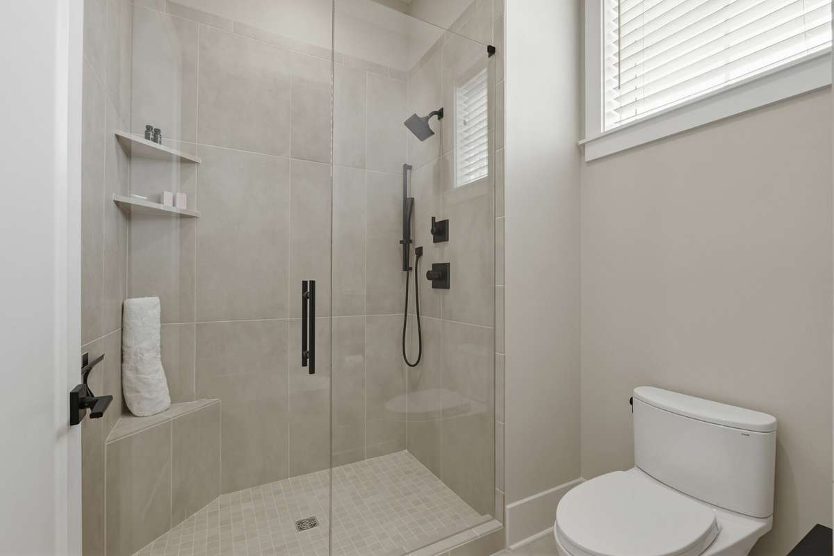 Walk-in shower with clean, modern design and custom tile finishes.