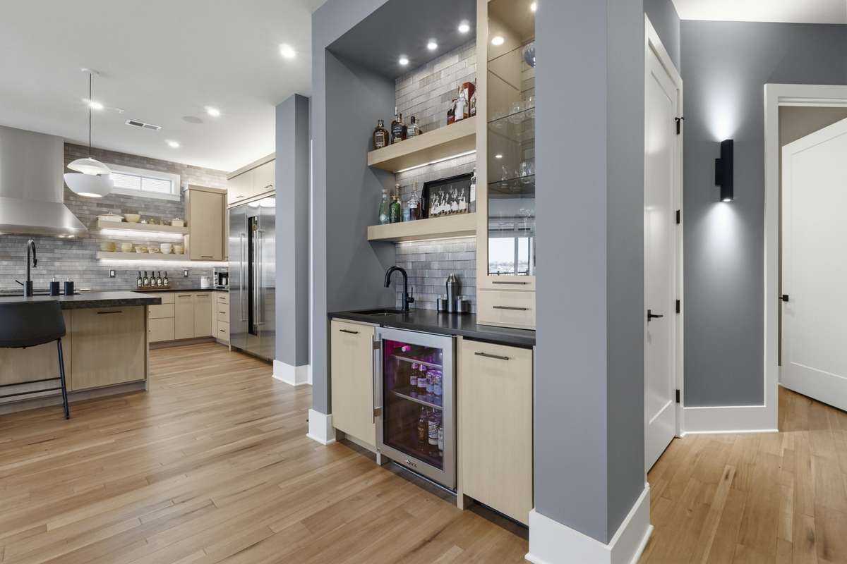 Conventiently located wet bar connects seamlessly to the kitchen and main living space.