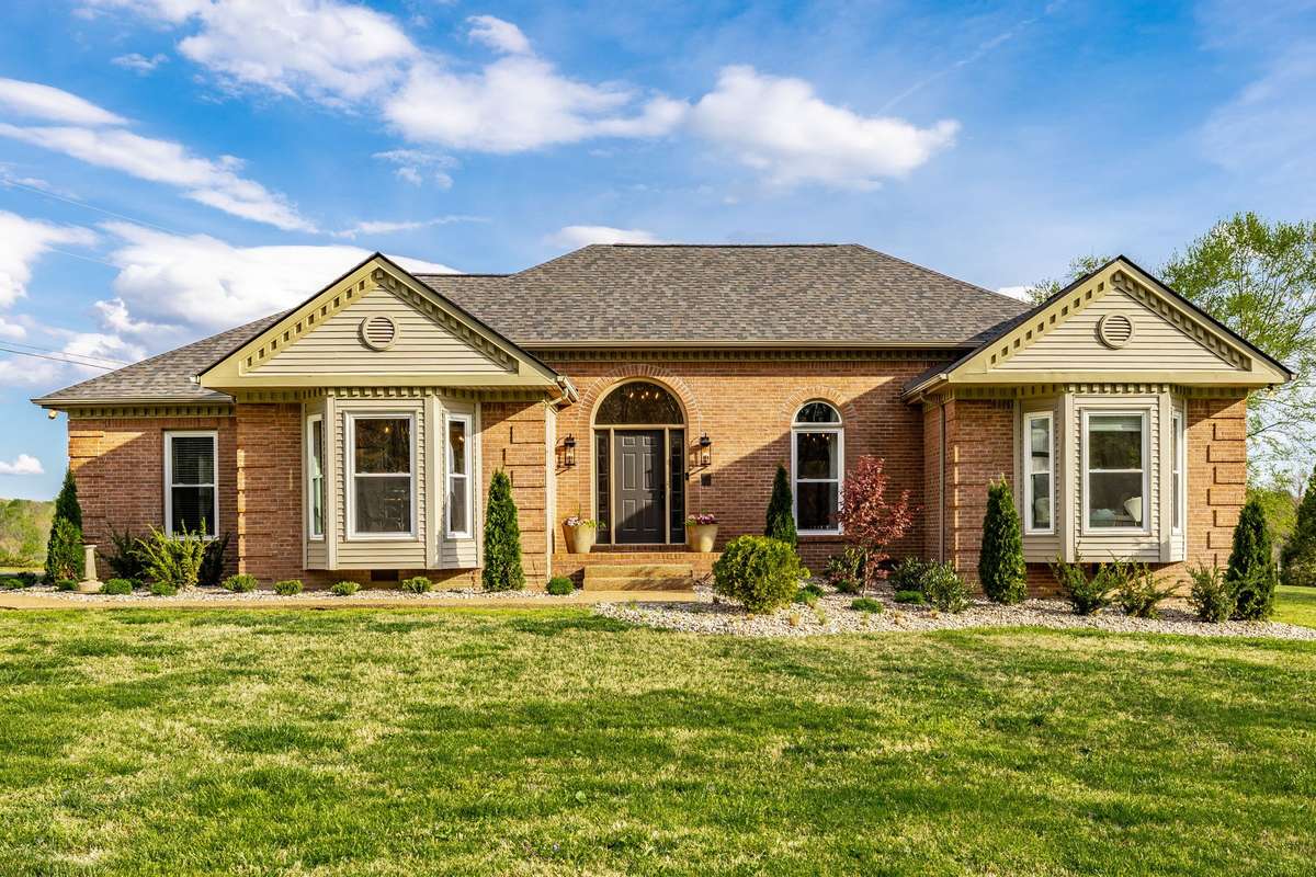 Front view of the All brick home with a new three-dimensional roof (installed 2024).