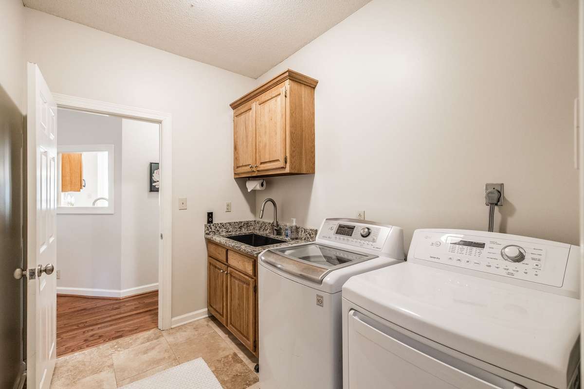 The utility room has a full sink, cabinet for storage and room for your washer and dryer.