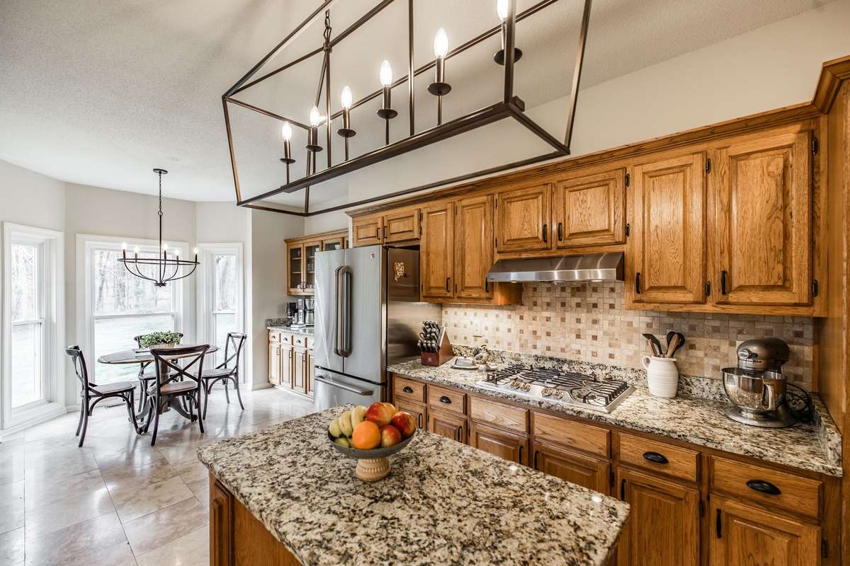 There is a gas cooktop, microwave, oven and a stainless French door refrigerator.