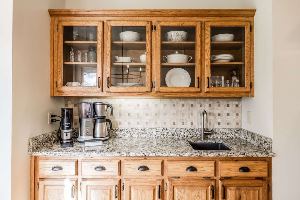 The extra cabinet space in the breakfast room allows storage to display your favorite dishes, a nice coffee bar, and a preparation sink.