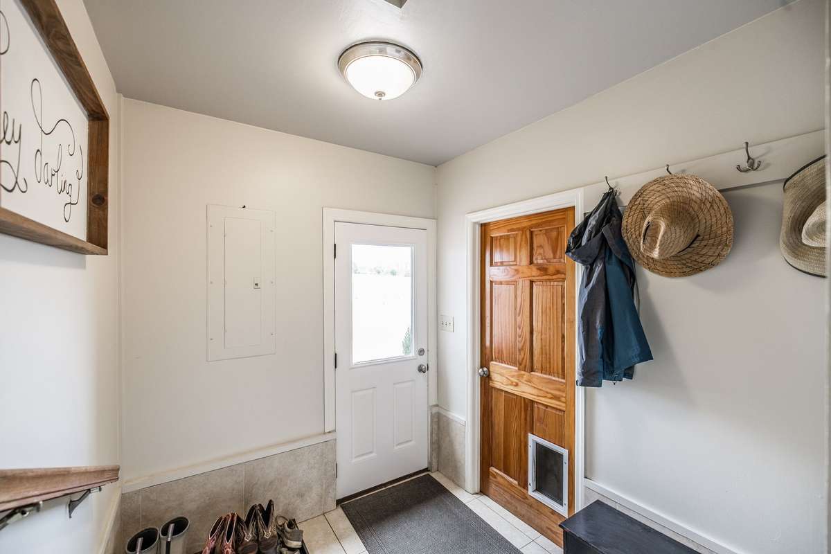 The back entrance into the mud room also has a pedestrian entrance into the garage. No farm is complete without a mud room.