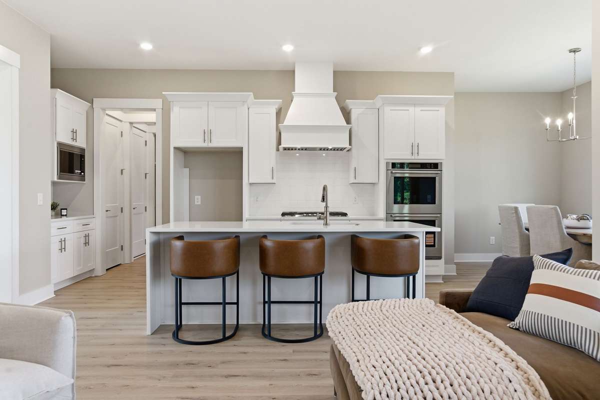 Gorgeous chef's quality kitchen with huge island, quartz counters, custom cabinetry, and upgraded Kitchen Aid appliances!