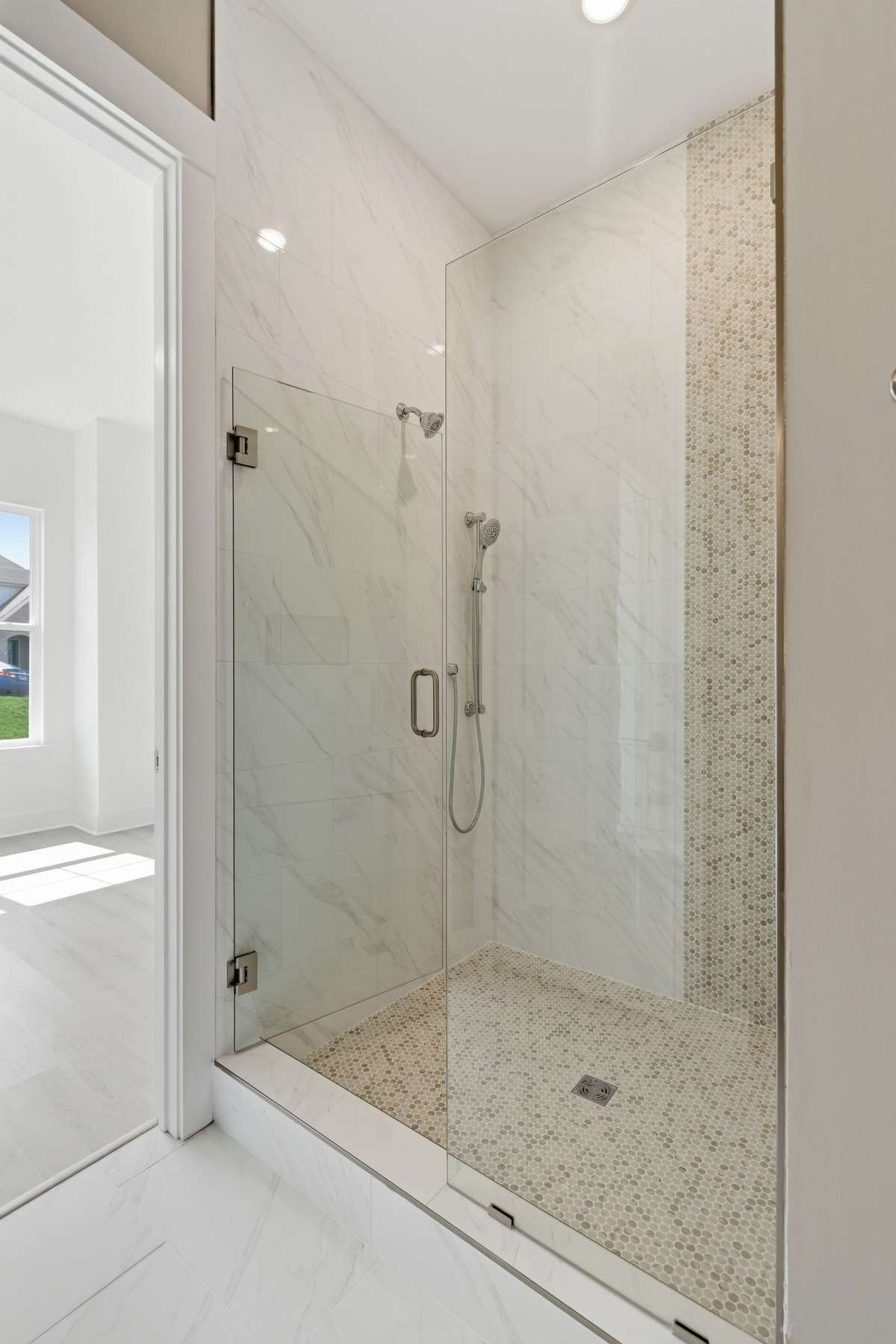 The large tiled primary bath walk-in shower