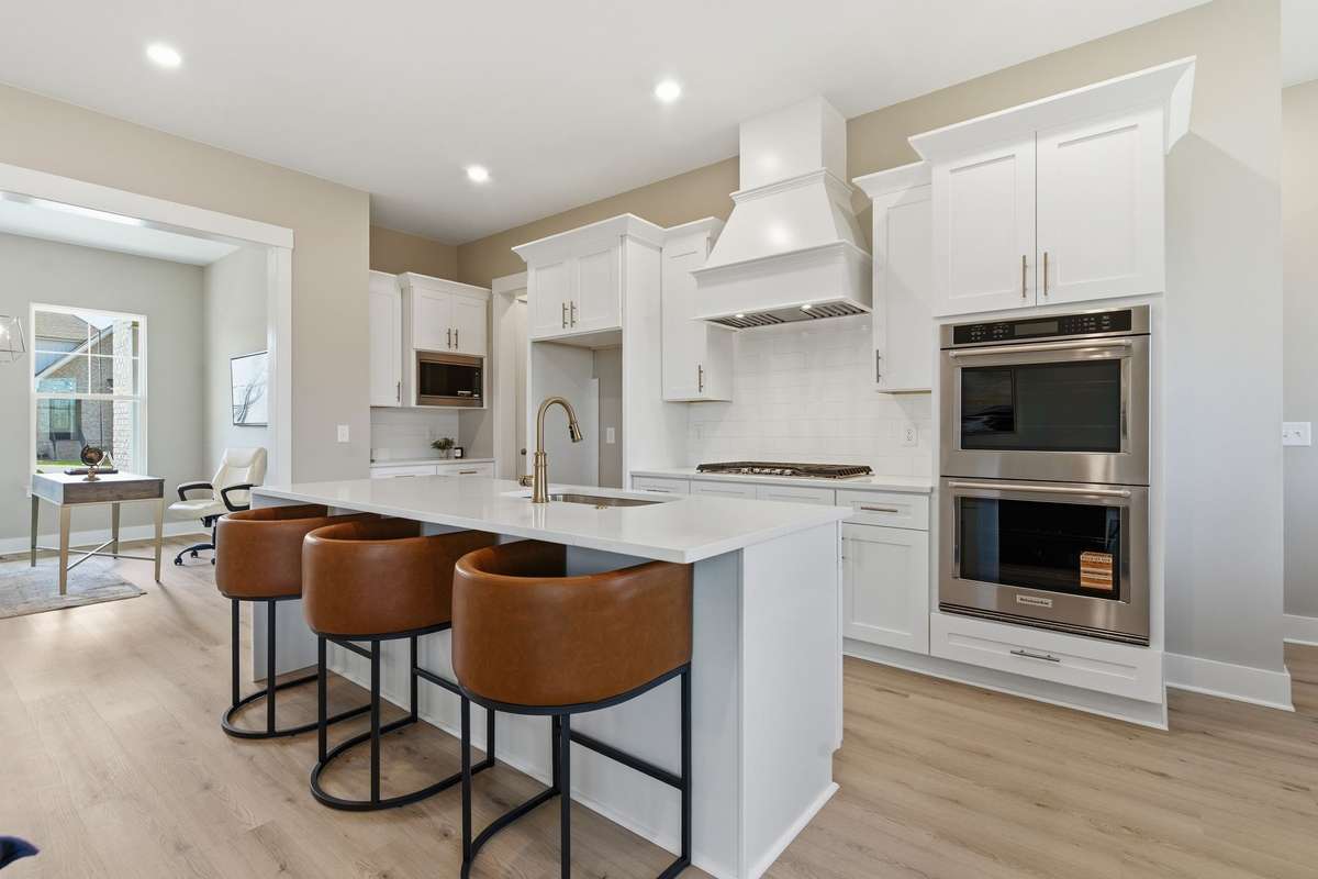 Gorgeous chef's quality kitchen with huge island, quartz counters, custom cabinetry, and upgraded Kitchen Aid appliances!