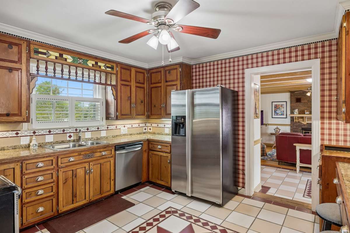 Kitchen with solid wood cabinets.  Owner is leaving behind new cabinet doors that have not been stained.