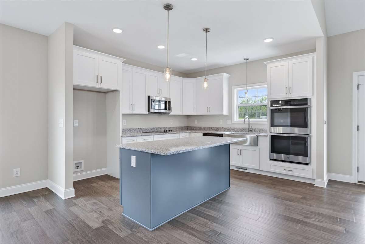 Modern kitchen featuring large island, granite countertops, and stainless appliances