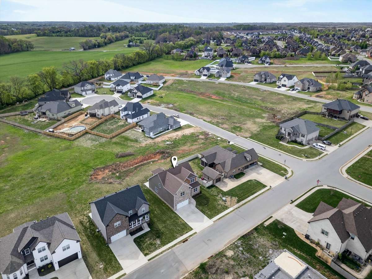 Aerial view showcasing the surrounding neighborhood and nearby homes.