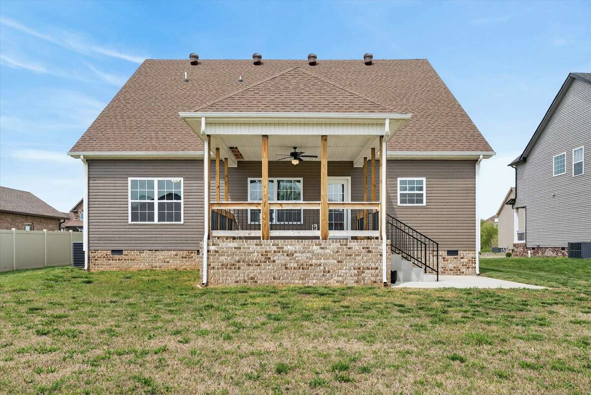 Back of home featuring covered patio and private backyard.
